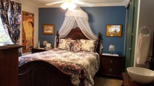 ein Schlafzimmer mit einem Bett und einem Waschbecken in der Unterkunft Bondy House Bed & Breakfast in Amherstburg