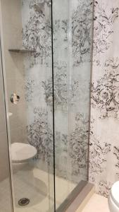 a bathroom with a glass shower with a sink at Bondy House Bed & Breakfast in Amherstburg