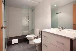 a bathroom with a toilet and a sink and a shower at Spacious apartment for families near Park Guell in Barcelona