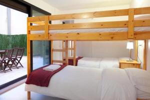a bedroom with two bunk beds and a patio at Spacious apartment for families near Park Guell in Barcelona