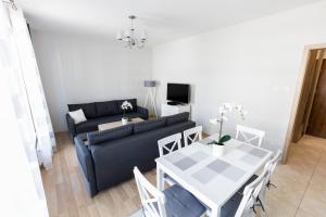 ein Wohnzimmer mit einem Sofa und einem Tisch in der Unterkunft Apartament 3d Szczecin in Stettin