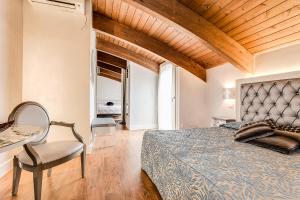 a bedroom with a bed and a table and a chair at Hotel Il Gabbiano in Cesenatico +282 photos