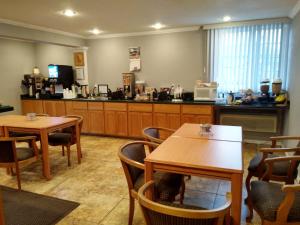 a restaurant with two tables and a counter at Americas Best Value Inn - Pendleton in Pendleton