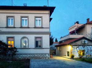 a large white house with a building at Vila Siega in Zadar