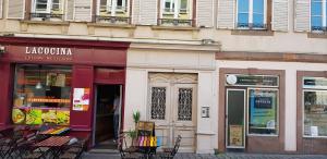 a store with chairs in front of a building at Appartement Cocoon Hypercentre in Strasbourg