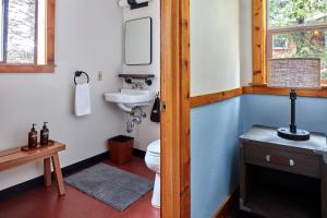 a bathroom with a toilet and a sink at Evergreen Lodge at Yosemite in Mather