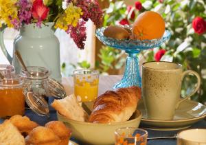 a table with a plate of bread and a cup of coffee at Maison du figuier in Lancié