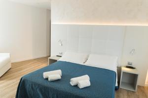 a bedroom with a bed with two pillows on it at Hotel Mara in Lido di Jesolo