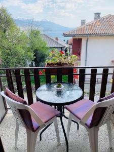 a table and two chairs on a balcony at Apartments Pendik in Ohrid
