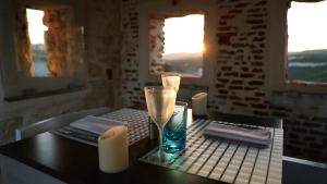 a table with a candle and a glass on it at Hotel Spa Genovese in Bonifacio