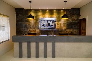 a kitchen with a counter with two pendant lights at Hotel Kanaan in Pimenta Bueno