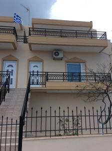 a house with a fence in front of it at Anatoli View in Agia Marina Nea Kydonias