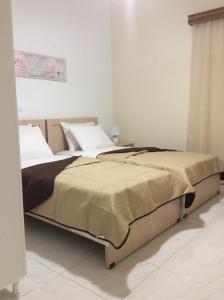 two beds sitting next to each other in a bedroom at Anatoli View in Agia Marina Nea Kydonias