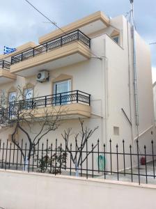 a white house with a fence in front of it at Anatoli View in Agia Marina Nea Kydonias