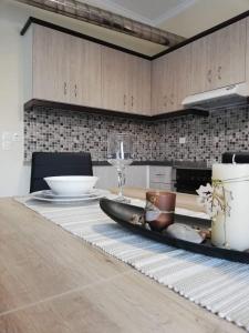 a kitchen table with a plate and a wine glass at Anatoli View in Agia Marina Nea Kydonias +17 photos