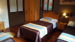 Postel nebo postele na pokoji v ubytování Hotel Asturias