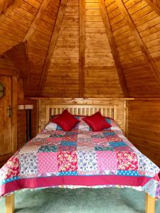 
a bed room with a bed with a wooden headboard at The Nest Glamping Pod in Dalmally
