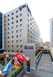 a hotel building with flags in front of it at Divan Istanbul City in Istanbul