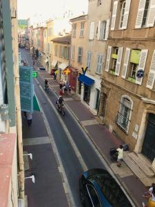 a city street with people riding motorcycles on the street at Appartement Design Centre ville in Saint-Tropez