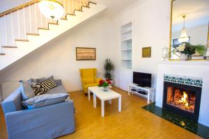 a living room with a couch and a fireplace at Presidential Suite Prince Machabeli in Tbilisi City