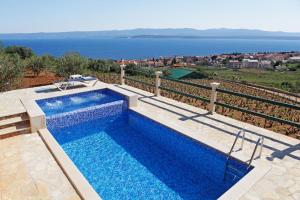 a swimming pool with a view of the water at Holiday home Nina in Bol