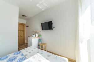 a bedroom with a bed and a tv on the wall at Willa Litoral in Jastarnia +34 photos