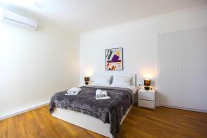 a bedroom with a bed with two towels on it at Presidential Suite Prince Machabeli in Tbilisi City
