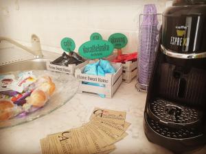 a kitchen counter with a coffee maker and a table with food at B&B Casa Alessandro in Scalea +8 photos