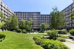 a large building with a green lawn in front of a building at Lisbon central apartment in Entrecampos in Lisbon