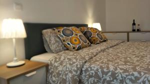 a bedroom with a bed and a table with a lamp at Lisbon central apartment in Entrecampos in Lisbon