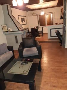 a living room with a couch and a table at Apartment NIKOLA ORANGE in Ohrid