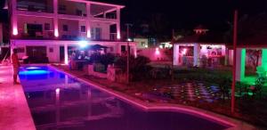a house with a swimming pool at night at Villa de Colores 3 Rooms 5 king Beds in Sosúa