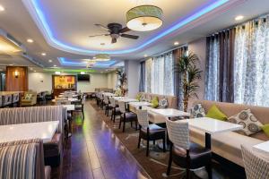 a restaurant with tables and chairs and a ceiling at Comfort Inn Anaheim Resort in Anaheim