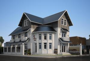 a large white building with a black roof at Sele House in Hà Tiên
