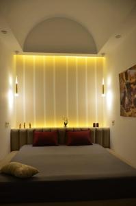 a bedroom with a large bed with lights on the wall at Sabat in Mahdia