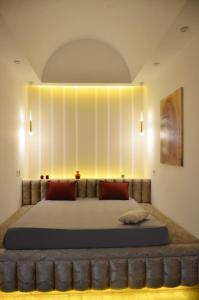 a bedroom with a large bed with a large headboard at Sabat in Mahdia