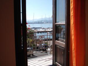 a view of a marina from an open window at Bed& Breakfast Maredomus in Milazzo