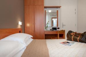 Postel nebo postele na pokoji v ubytování Hotel Pierre
