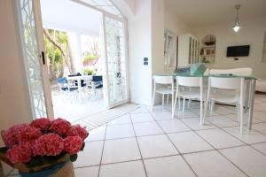 a kitchen and dining room with a table and chairs at Edri beach house in Pontecagnano