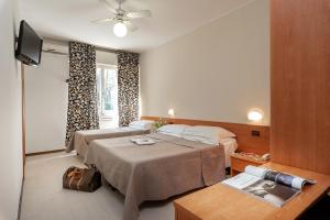 Postel nebo postele na pokoji v ubytování Hotel Pierre