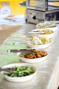 a buffet line with bowls of food on a counter at Wan Jin Hot Spring in Wanli District