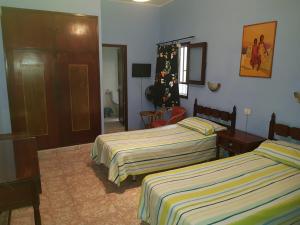 a bedroom with a bed, desk, and chair at Hostal 7 Soles in Las Palmas de Gran Canaria