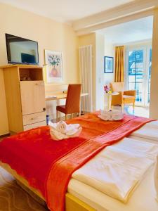 ein Hotelzimmer mit einem großen Bett mit Handtüchern darauf in der Unterkunft Aparthotel Kleine Perle in Cuxhaven