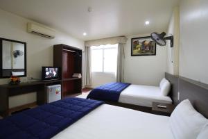 Säng eller sängar i ett rum på Catba Dream Hotel