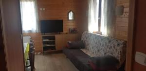 a living room with a couch and a flat screen tv at ISATIS 19 in Ignaux