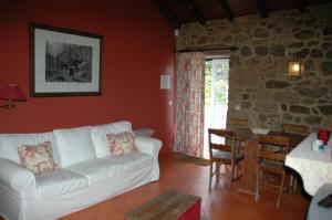 a living room with a white couch and a table at Quinta da Casa Alta in Valença