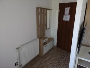 a small room with a hallway with a door and a stairway at Holsteiner Hof in Heist