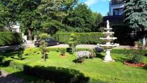 a garden with a fountain in the grass at Noclegi-Pokoje goscinne Lublin in Lublin