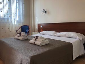 Säng eller sängar i ett rum på Case Vacanze Ancora