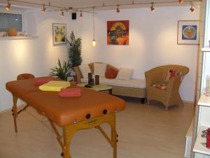 a living room with a table and a couch at Appartement Harmonie & Balance in Leogang